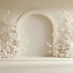 an arch in the wall with white flowers on it and another archway to the right