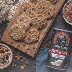 an assortment of cookies, granola and other food items on a wooden table top