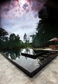 an artistic view of a pool surrounded by trees