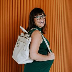 Natasha is the bag for the woman that does it all. This bag seamlessly moves from work bag, to mom bag, to travel bag. You can carry it as a backpack, or purchase one of our bag straps to make it a crossbody/shoulder bag. It can also be used with our stroller straps for extra momming functionality. Natasha has the perfect blend of style and organization to get you through all of life's big, and small, moments. Features Convertible: Wear it as a backpack or by the top handle, or upgrade with a cr Chic Leather Backpack With Detachable Strap For On-the-go, Chic Leather Backpack For Travel, Modern Diaper Bag With Adjustable Strap For On-the-go, On-the-go Satchel Diaper Bag With Detachable Strap, Everyday Satchel Backpack With Detachable Strap, Daily Satchel Backpack With Detachable Strap, Chic Backpack With Adjustable Strap And Double Handle, Satchel Backpack For Everyday Use, Chic Backpack With Detachable Strap And Double Handle