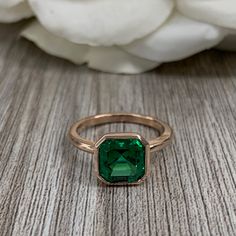 "The ring pictured is a lab created emerald #7086 Emerald is the May Birthstone -Approximate total carat weight: approx. 2.20ctw diamond equivalent -Center Stone Size: 8x8mm - approx. 2.20ct diamond equivalent -Center Stone Shape: asscher cut -Gem Type: lab created emerald -Stone Clarity: VS2 -Stone Color: Green -Moh's Scale: 8.5 hardness -Metal Type and Purity: 14k rose gold -Setting: bezel set -Stock Ring Size: 7 -Country of Manufacturing: USA (Michigan) For customization please contact us. If Asscher Cut Ring, Emerald Wedding Rings, Infinity Jewelry, Bezel Set Ring, Ladies Ring, May Birthstone, Asscher Cut, Emerald Engagement, Ring Pictures