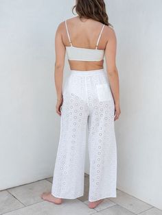 Our Daisy Eyelet Coverup comes in pants now too. This coverup features a delicate daisy eyelet pattern, a relaxed elastic waist which makes them perfect to throw over your favorite swimsuit. From the beach to the pool deck or right on to lunch in town, these pants are the coverup of the season. White Beachwear Pants With Elastic Waistband, Resort Season Loungewear Bottoms With Elastic Waistband, Elastic Waistband Bottoms For Loungewear, White Summer Bottoms For Warm Weather, Beachwear Bottoms For Resort Season, Summer Loungewear Pants For Resort Season, White Bottoms For Resort Season Vacation, White Bottoms For Summer Warm Weather, Summer Resort Loungewear Pants