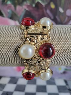 "This vintage bracelet has red acrylic and faux pearl accents.  Size:  7 1/4\" L x 1 1/4\" W Maker:  Unknown. The bracelet is in good vintage condition and the pearls show little wear. All the orders are carefully packed and mailed out with USPS. Buy with confidence, we have a FIVE STAR feedback.  For more beautiful vintage finds, please check my shop: https://www.etsy.com/shop/ContessasCollection" Red Retro Bangle Jewelry, Elegant Red Stretch Bracelet For Party, Retro Red Bracelet Jewelry, Vintage Red Bracelets For Party, Red Vintage Party Bracelets, Red Metal Costume Jewelry Bracelets, Red Metal Costume Jewelry Bracelet, Formal Red Metal Bracelets, Glendale Az