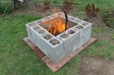 an outdoor fire pit made out of cinder blocks