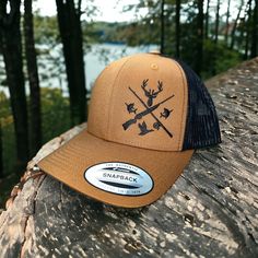 This awesome fishing and hunting design is embroidered on premium quality Yupoong six-panel trucker hat. The design placement is on the right side of the hat when looking at it.  How to Order: 1. Choose your hat color from the pictures. (We have a lot more colors available. Send us a message to check what we have available)  2. Pick the thread color you would like for the design.  Message us with if you have any questions.  Washing instructions: Hand wash cold only, wipe dirty areas only with a Trucker Cap For Outdoor, Trucker Hat With Flat Bill For Hunting, One Size Fits Most Snapback Fishing Hat, One Size Fits Most Snapback Fishing Cap, Trucker Hat With Curved Brim For Hunting, Trucker Cap For Camping, Adjustable Hunting Baseball Cap With Flat Bill, Outdoor Trucker Hat Snapback, Outdoor Trucker Hat Snapback Style