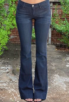 Vintage meets modern in these Judy Blue Fitted Trouser Jeans. With subtle bell-bottom appeal, these dark wash jeans feature a fitted thigh, floor-length flared leg, and 2” ankle hem. Classic 5-pocket design with zipper fly and button closure. Fits true to size Flare leg fit. 34” inseam Unlined. 59% Rayon, 23% Cotton, 17% Polyester, 1% Spandex Machine wash cold inside out/tumble dry low Made in USA. Dark Blue Bell Bottom Jeans, Dark Blue Flare Jeans, Skirt Over Jeans, Dark Flare Jeans, Blue Flared Jeans, Trip List, Vintage Flare Jeans, Vintage Meets Modern, Dark Wash Flare Jeans