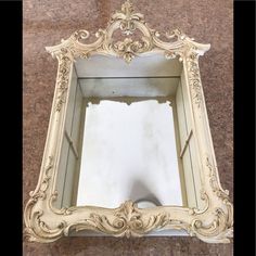 an old mirror is sitting on the floor