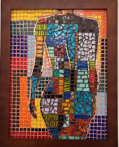 an art piece made out of colored glass and wood with a man's body in the center