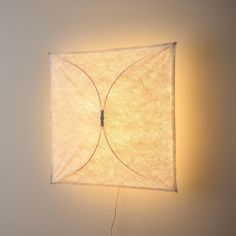 a light that is on the side of a wall with a white cloth covering it