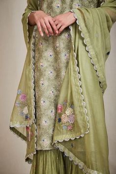 Olive green straight kurta with multi-colour resham thread worked floral motifs, eyelet detail and sequin- pearl embellishments. Comes with gathered flounce hem pants and scallop dupatta.
Component: 3
Embroidered
Neckline: Round
Sleeve Length: Sleeveless
Fabric: Mul
Color: Green
Gathered flounce hem
Side slits
Scallop dupatta
Cutwork trims - Aza Fashions Scallop Dupatta, Kurta Set For Women, Hem Pants, Straight Kurta, How To Hem Pants, Embroidered Neckline, Thread Work, Kurta Set, Floral Motifs