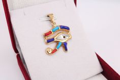 Colored Eye of Horus 18K gold Pendant | handmade jewelry Egyptian jewelry evil eye pendant mythology jewelry eye necklace Horus charm 3.2 Gr Weight Approximate : 3.2 Gr Height : 1.2" = 31 mm Width : 1" = 27 mm ✔ IT IS Tested & SIGNED WITH THE EGYPTIAN Gold Government HALLMARK FOR 18K GOLD to Ensure      Authenticity. ✔ Lovely gift idea ABSOLUTELY GORGEOUS, LOOKS FABULOUS ON. ✔ 100% Egyptian handmade. ✔ Condition: A brand-new, exactly as on the photos. ★ GIFTS ✔ All items are packaged in a paper Symbolic Pendant With Diamond Eyes, Gold Plated Evil Eye Amulet Jewelry, Gold Plated Evil Eye Symbolic Jewelry, Gold Plated Evil Eye Round Pendant Jewelry, Spiritual Gold Plated Evil Eye Jewelry, Symbolic Gold Plated Evil Eye Jewelry, Symbolic Evil Eye Jewelry, Gold Evil Eye Amulet Jewelry, Brass Evil Eye Jewelry As A Gift