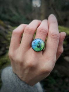 Beautiful and Unique, Resin Ring with a tiny forget-me-not flower inside- a botanic artifact hidden under the resin cabochon on a rustic, vintage-style bronze base.  Natural, magical, and elegant ring for nature lovers, bohemians, and unique people. Perfect as an unusual gift.  Adjustable size. Whimsical Green Round Jewelry, Artistic Adjustable Flower Jewelry, Green Flower Ring Gift, Adjustable Artistic Flower Jewelry, Bohemian Butterfly Ring For Gift, Vintage Handmade Butterfly Ring Gift, Handmade Vintage Butterfly Ring For Gift, Handmade Vintage Butterfly Ring Gift, Handmade Green Flower Ring