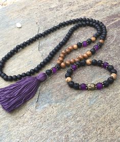 108 bead mala & bracelet 108 bead mala with 100% Egyptian cotton, handmade tassel. Made with: Matte black wooden beads (8mm), brown robles wood beads (8mm), Lava rock (8mm), matte purple glass beads (8mm) These 108 beaded necklace measures 29 inches in lengthThe total hanging length is 18 inches. Tassel is 2.5 inches The symbol of the Buddha, with his compassionate smile, reminds us to strive to develop kindness, peace & love so that we can be a true friend to all beings. Lava stone is o Wooden Beads Jewelry, Wooden Bead Jewelry, Spiritual Beads, Matte Purple, Antique Gold Earrings, Mala Beads Bracelet, Mala Jewelry, A True Friend, Mala Bead Necklace