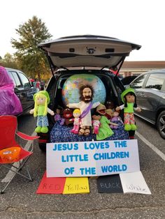 the back of a car with jesus loves the little children of the world