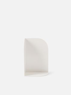 an empty white shelf against a white background