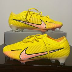 a pair of yellow nike soccer cleats on display