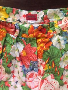 Cool Kenzo Paris multi colored floral printed high waisted shorts. Perfect 80's high fashion street wear. Fabric is a medium weight cotton. Shorts have pleats in the front, darts at the waist in back. Side front pockets. Cuff at the shorts hem. Front plastic zipper with button at the waist. Label Kenzo Paris, Size 38, 100% cotton, wash cold, hang dry. Very good vintage condition with no fabric or sewing flaws. Measurements Waist 62cm/ 24.5inches Hips 102cm/ 40inches Waist to hem 44cm/ 17inches M Retro Floral Print Bottoms For Spring, Retro Printed Bottoms For Spring, Retro Cotton Shorts For Spring, Retro Floral Print Summer Bottoms, Retro Summer Floral Print Bottoms, Cotton Bottoms With Floral Print, Multicolor Floral Print Cotton Shorts, Multicolor Floral Print Short Bottoms, Green Cotton Bottoms With Floral Print