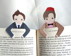 an open book with paper cutouts of two people