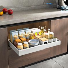 an open drawer in a kitchen filled with condiments