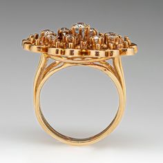 This beautiful diamond ring features a gallery with an openwork design and is centered with one (1) old European cut diamond set into a six-prong setting. The center stone is bordered with eight (8) old European cut diamonds set into six- prong settings. The ring measures 24.5mm at the top, rises 8.2mm above the finger, tapering to 4.1mm wide and 1.3mm thick at the base of the shank. The ring is currently a size 6 and has a great patina. Antique Diamond Ring With Prong Setting, Victorian Cluster Ring With Diamond Accents, Victorian Diamond Ring With Diamond Accents, Victorian Diamond Ring With Round Cut, Victorian Style Diamond Ring With Accents, Antique Diamond Cluster Ring With Brilliant Cut, Antique Cluster Diamond Ring With Prong Setting, Antique Cluster Diamond Ring With Accents, Antique Brilliant Cut Diamond Cluster Ring