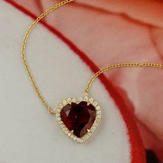 Embrace romance with this princess necklace crafted from 14K solid gold. A heart-shaped garnet gemstone takes center stage, accented by pave diamonds, exuding elegance and allure. Perfect for adding a touch of sophistication to any attire, this necklace captures the essence of love and grace with its exquisite design. This Necklace is handmade in 14k Gold : 2. 839 grams , with and Diamond : 0. 17 cts  Garnet : 3. 61 cts (ACE-3361)  This jewelry is made by hand featuring detailed workmanship. Be careful to avoid dropping or banging as physical impacts can result in damage to the pieces including stones falling off. To care for your jewelry, take caution to keep away from harsh chemicals, Perfume, and Water. You may wipe with a clean polishing cloth to maintain a beautiful shine. Keep in min Ruby Heart Pendant Necklace For Wedding, Elegant Ruby Heart Cut Jewelry, Elegant Heart Cut Ruby Jewelry, Ruby Heart Cut Gemstone Necklace, Heart Cut Ruby Gemstone Necklace, Fine Jewelry Ruby Necklace For Valentine's Day, Heart-shaped Ruby Gemstone Necklace, Elegant Ruby Necklace With Heart Charm, Elegant Heart Cut Ruby Necklaces