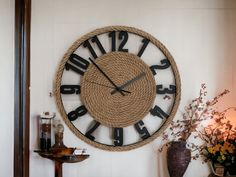 a large clock on the wall with rope around it