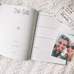 an open book with a couple's photo on the cover and ticket to trip one