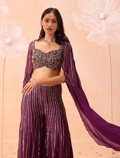 Step into elegance with this sharara set, embellished with intricate zari and sequin work. The ensemble includes a beautifully embroidered blouse with detailed cutwork on the neckline and elegant cape sleeves. Perfect for adding a touch of sophistication to any occasion. Blouse And Sharara, Wine Pants, Pre Bridal, Organza Blouse, Indian Wedding Wear, Embroidered Pants, Cape Sleeves, Sharara Set, Silk Organza