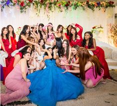 a group of women in dresses posing for a photo