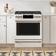 a white stove top oven sitting inside of a kitchen