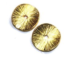 two gold toned buttons on a white background