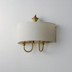 a wall light with a white shade on it