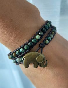 Introducing the Elephant Charm Bracelet with African Turquoise Beads! This bracelet is more than just a beautiful piece of jewelry. It's a connection to the magical land of Africa and the power of mother earth. The elephant charm is a symbol of strength, wisdom and luck. It's said to be a powerful protector and bring good fortune to those who wear it. The African turquoise beads are known for their metaphysical properties. They're said to help balance your mind, body, and spirit. Wearing this br Earthy Turquoise Bracelets For Festival, Adjustable Turquoise Beaded Bracelets In Holistic Style, Hand Wrapped Turquoise Spiritual Wrap Bracelet, Turquoise Hand-wrapped Jewelry For Meditation, 108 Beads Friendship Bracelet Jewelry, 108 Beads Friendship Bracelet, Turquoise Symbolic Adjustable Jewelry, Spiritual Nickel-free Turquoise Beaded Bracelets, Bohemian 108 Beads Friendship Jewelry