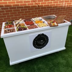 a white cooler with lots of different types of food on it's front and side