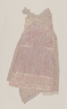 two pieces of pink and blue material on a white surface with an image of a woman's dress