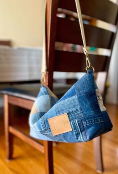 a pair of jeans hanging from a wooden chair