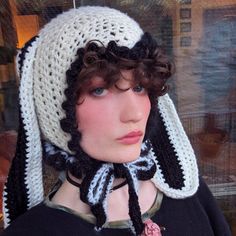 a mannequin wearing a crocheted hat and scarf