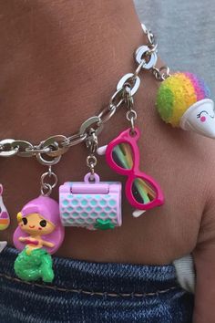 a person wearing a bracelet with charms on it