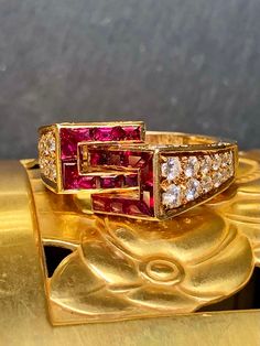 An incredible piece c. the late 80's early 90's bay famous French maker, Piaget. Crafted in deep 18K yellow gold, it has been adorned with gorgeously intense natural rubies and the finest quality diamonds. There is approximately .72cttw in E-F Vs1+ diamonds as well as 2cttw in rubies. Being familiar with the name, its quality should not be in question. This piece is accompanied by its original inner and outer boxes. Dimensions/Weigh: Ring weighs 7.3g and is a size 6.25. It can be sized, but one Luxury Gold Rectangular Ruby Ring, Art Deco Gold Ruby Ring, Vintage Gold Ruby Ring With Vvs Clarity, Vs1 Diamond, Ruby Diamond, Natural Ruby, Quality Diamonds, Cocktail Ring, Cocktail Rings