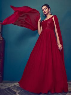 Are you looking for a gown that will elevate your look for a wedding, reception, party, sangeet, or to stand out as a beautiful bridesmaid? Look no further than the Mesmerizing Red Sequins Georgette Ready-Made Bridesmaid Gown, available now from Ethnic Plus. With its stunning red color and intricate sequin work on delicate georgette fabric, this gown is sure to catch the eye of everyone in the room. The attached dupatta adds an extra touch of elegance and sophistication to this already show-stop Glamorous Georgette Saree Dress, Glamorous Floor-length Gown For Festive Season, Red Bridesmaid Ball Gown, Glamorous Georgette Anarkali Set For Wedding, Glamorous Festive Georgette Gown, Festive Evening Lehenga Maxi Length, Festive Evening Maxi Lehenga, Evening Festive Maxi Lehenga, Festive Evening Maxi Length Lehenga