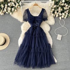 Immerse yourself in the ethereal charm of the Midnight Whisper Navy Tulle Cocktail Dress. This dress is a true embodiment of fairy-tale elegance, designed for those who appreciate the delicate interplay of shadow and light. The bodice of the dress is a masterpiece of design, featuring a corset-style lace-up back that not only provides a customizable fit but also adds a vintage touch to the modern silhouette. The soft cap sleeves and the sheer overlay on the bodice are adorned with subtle dotted Fairycore A-line Party Dress, A-line Fairycore Dress For Party, Ethereal Ruffled Dress For Party, Elegant Knee-length Tulle Midi Dress, Elegant Mini Dress For Garden Party And Prom Season, Elegant Mini Dress For Garden Party During Prom Season, Elegant Summer Tulle Corset Dress, Summer Party Corset Dress With Tulle Skirt, Summer Midi Dress With Sweetheart Neckline And Tulle Skirt