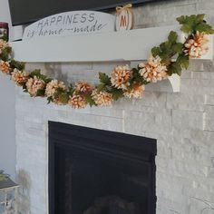 a fireplace decorated with fake flowers and leaves