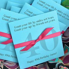 blue envelopes with pink ribbon tied around the numbers forty and forty birthday cards for someone's 90th birthday