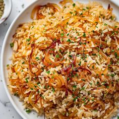 a white plate topped with rice and onions