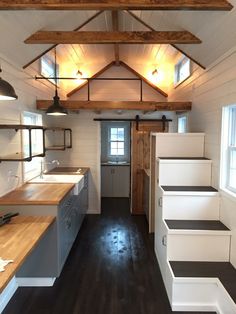 this is an image of a kitchen with stairs leading up to the door and windows