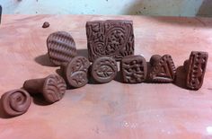 chocolate molds sitting on top of a wooden table next to some other shapes and sizes