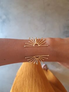 This unique wrist cuff bracelet is a statement piece, feminine and complementing. Its' design is inspired by the sun and is adjustable.- Length- 5.7 inches (14.5 cm)If you need a different size, just specify in the note to seller and I will comply :)- Width- the sun part measures about 2 inches wide (5 cm)- Material- 24k gold over brass (nickel free) or solid sterling silver- Arrives in a lovely gift box, ready to give as a gift- Ships within 3 business daysPart of my new "Zoa" collection- Zoa m Gold Sun Bracelet, Statement Bracelets Cuffs, Sun Inspired Jewelry, Gold Cuff Bracelet Women, Cuff Bracelets Gold, Brass Jewelry Design, Sun Clothes, Gold Jewelry Bracelets, Gold Cuff Bracelets