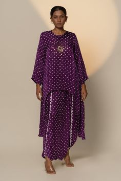 Purple full sleeves gajji silk high low kurta with all over quad bandhani motif pattern and cowrie shells embellishments at the centre. Paired with a matching overlapped dhoti skirt. - Aza Fashions Bandhani Skirt, Bandhani Kurta, High Low Kurta, Dhoti Skirt, Cowrie Shells, Motif Pattern, Women Skirt, Skirt For Women, Cowrie Shell