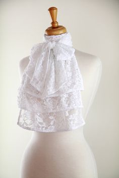 A lovely lace jabot would be a delightfully unique edition to any vintage fashion lover's wardrobe!! Pair this ruffled fashion collar with a little black dress for a simply elegant evening look, or wear it under a tuxedo jacket with jeans and it has rock star appeal!! This handmade neckwear frill features a cascade of gorgeous floral lace and a wrap around style neckband that ties in a bow in the front to complete the vintage-inspired look!!  Stretch lace fabric gives it an unusually comfortable Elegant Formal Lace With Lace Patchwork, Elegant Scalloped Lace For Formal Occasions, Chic Wedding Lace With Lace Trim, White Lace Patchwork For Formal Occasions, White Lace With Patchwork For Formal Occasions, Formal White Lace With Patchwork, Spring Wedding Lace With Lace Collar, Elegant Lace Patchwork For Ceremony, Elegant Lace With Patchwork For Ceremony