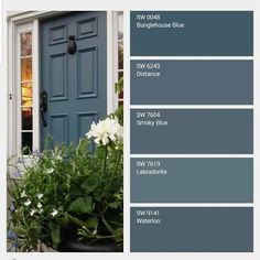 the color scheme for this front door is blue and has white flowers in pots next to it